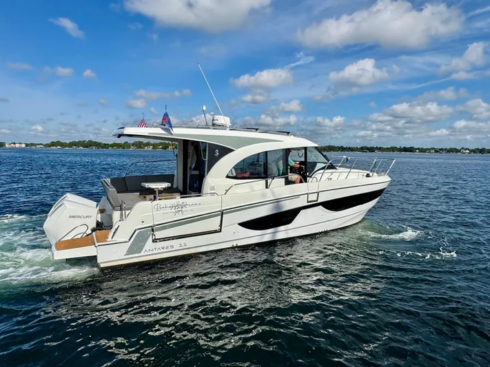  Yacht Photos Pics 2024 Beneteau Antares 11 cruising on a sunny day with clear skies.