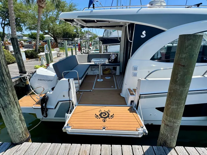  Yacht Photos Pics 2024 Beneteau Antares 11 docked, showcasing spacious deck and modern design.