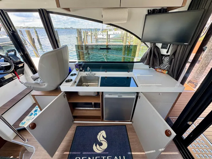  Yacht Photos Pics 2024 Beneteau Antares 11 interior kitchen with modern appliances and waterfront view.