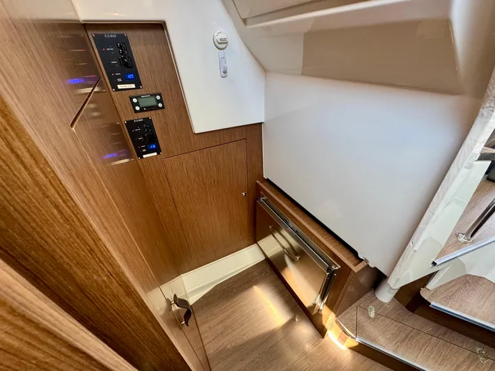  Yacht Photos Pics 2024 Beneteau Antares 11 interior with wood paneling and control panels.