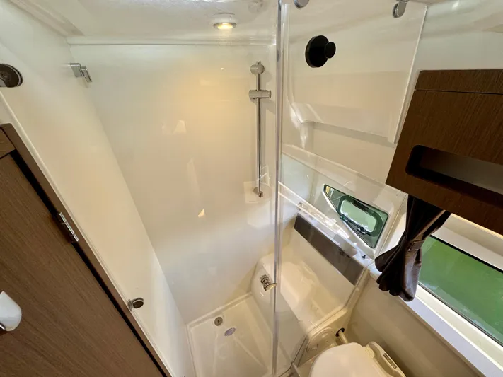  Yacht Photos Pics 2024 Beneteau Antares 11 bathroom with modern shower and sleek design.