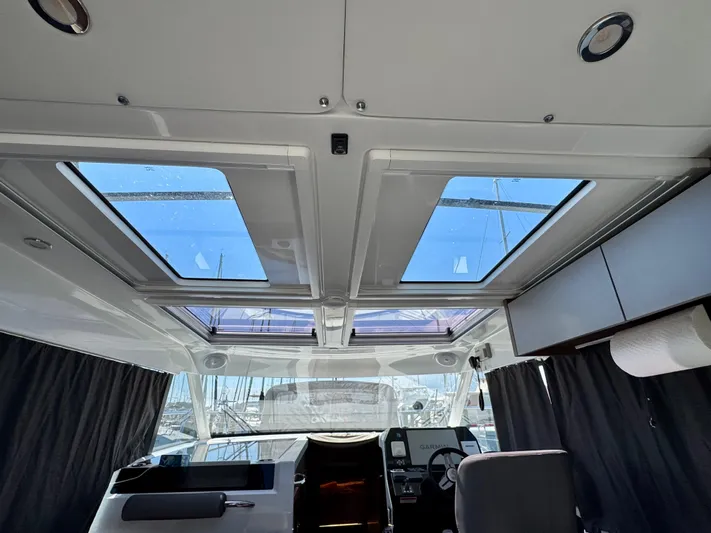  Yacht Photos Pics Interior view of 2024 Beneteau Antares 11 with skylights and modern cockpit design.