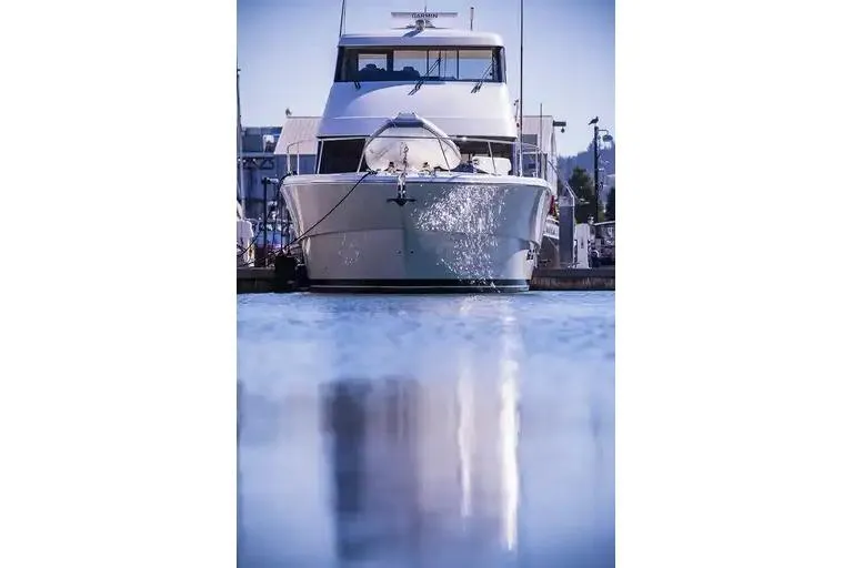  Yacht Photos Pics 2017 Maritimo M 51 yacht docked, reflecting on calm water.