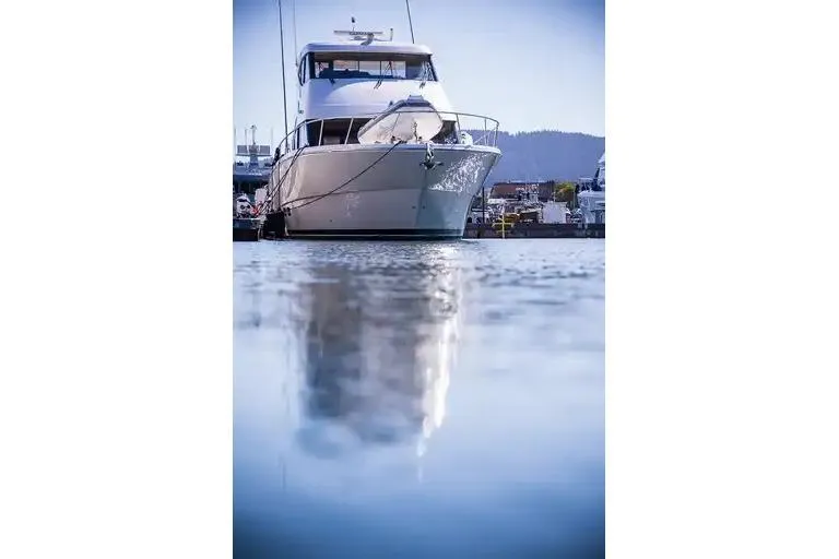  Yacht Photos Pics 2017 Maritimo M 51 yacht docked, reflecting on calm water.