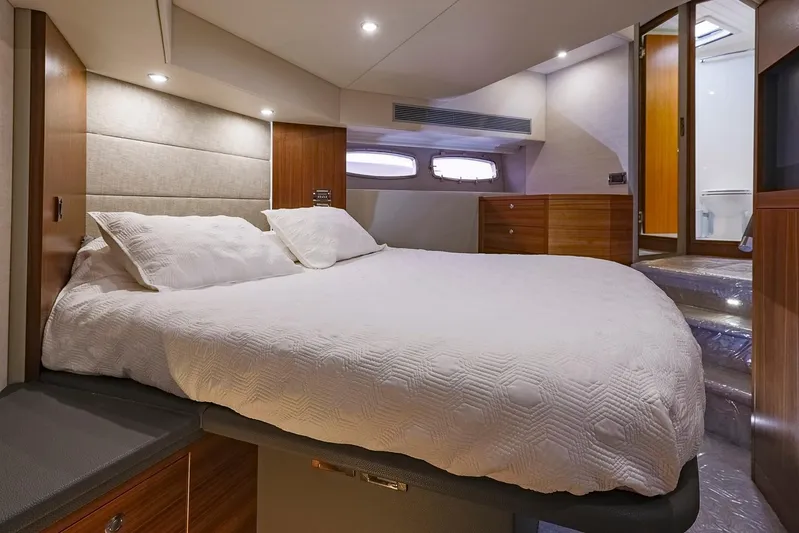  Yacht Photos Pics Luxurious bedroom interior of 2017 Maritimo M 51 yacht with elegant bedding and wood accents.