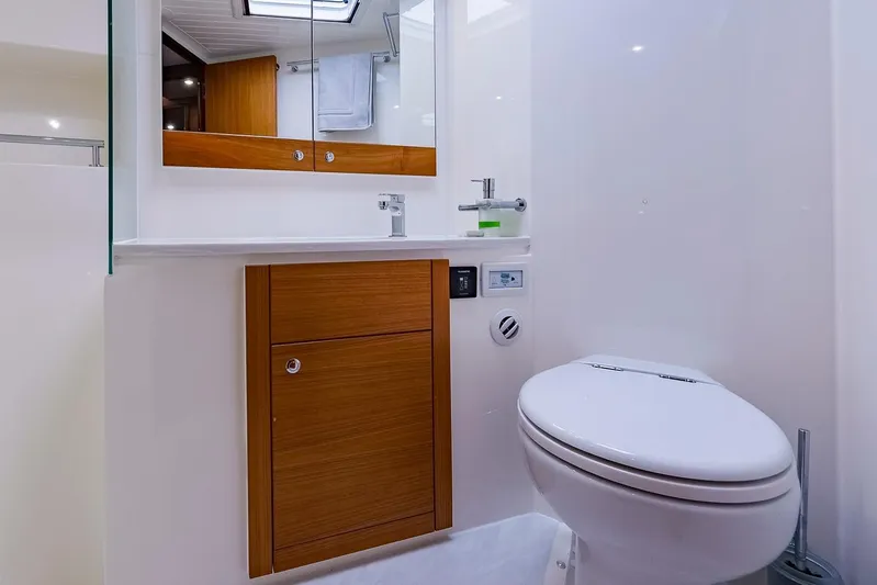  Yacht Photos Pics Luxurious bathroom in 2017 Maritimo M 51 yacht with modern fixtures and wooden cabinetry.