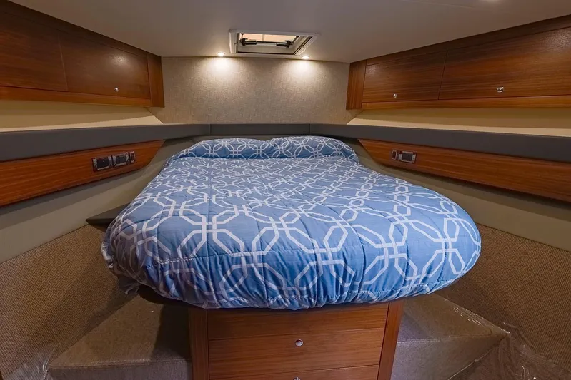  Yacht Photos Pics Luxurious cabin interior of 2017 Maritimo M 51 yacht with cozy bed and wood finish.