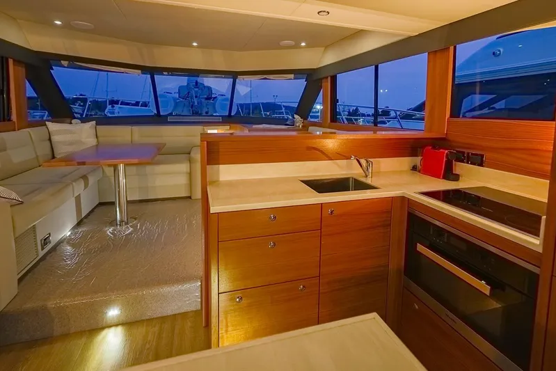  Yacht Photos Pics Luxurious interior of 2017 Maritimo M 51 yacht with modern kitchen and seating area.