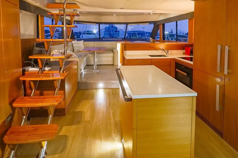  Yacht Photos Pics Luxurious interior of 2017 Maritimo M 51 yacht with modern kitchen and elegant staircase.