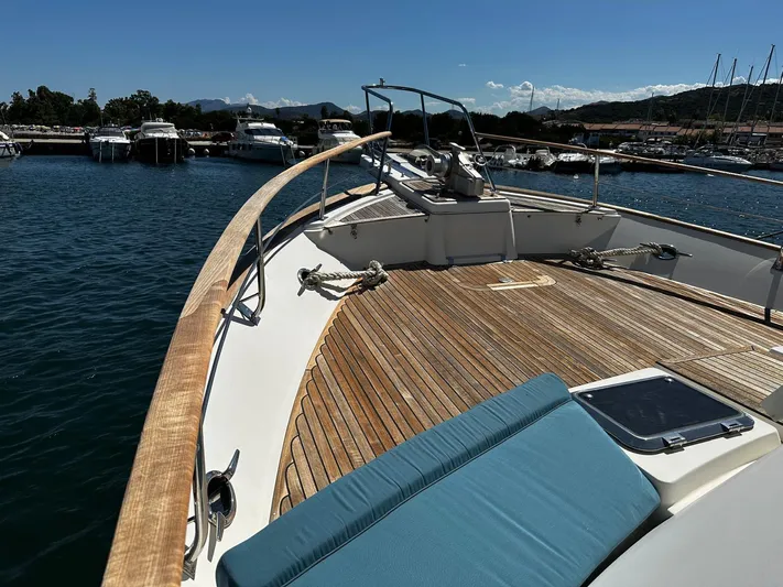 Smaragd Yacht Photos Pics Bow view of 2003 Fleming 55 yacht with wooden deck and blue cushion in marina.