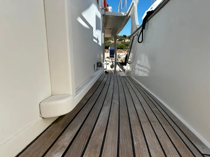 Smaragd Yacht Photos Pics Side deck of a 2003 Fleming 55 yacht with wooden flooring.