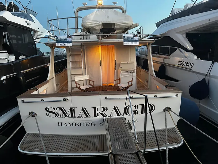 Smaragd Yacht Photos Pics Luxury yacht "Smaragd" docked, Fleming 55 model, 2003, with elegant deck chairs and lighting.