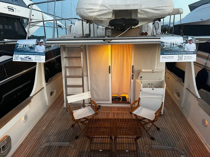Smaragd Yacht Photos Pics 2003 Fleming 55 yacht deck with chairs, table, and sale signs by Skippern Yachts.