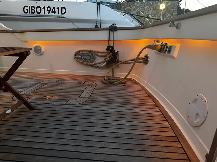 Smaragd Yacht Photos Pics Teak deck of 2003 Fleming 55 yacht with ropes and ambient lighting.
