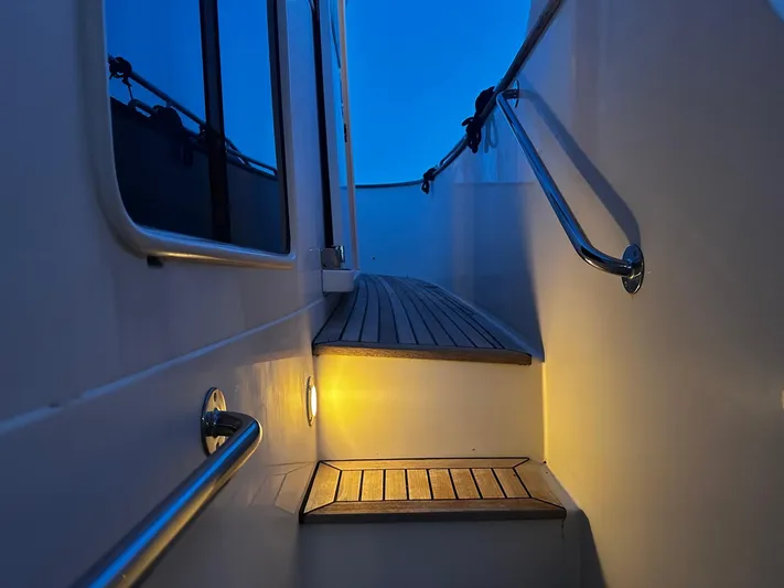 Smaragd Yacht Photos Pics Illuminated steps on a 2003 Fleming 55 yacht at dusk.