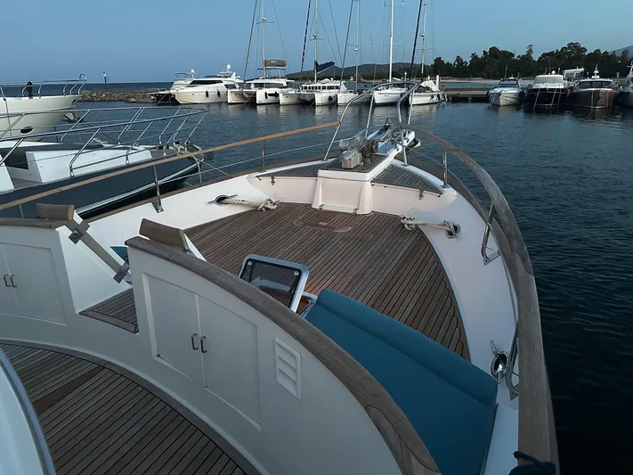 Smaragd Yacht Photos Pics 2003 Fleming 55 yacht with wooden deck, docked in a marina with other boats.