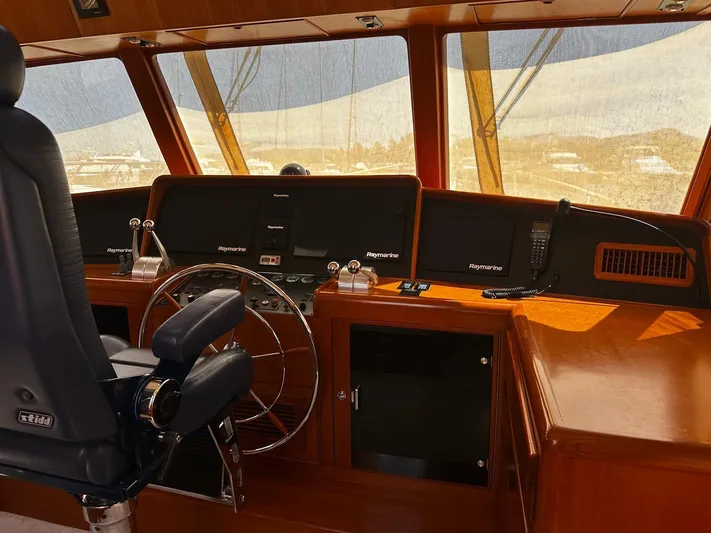 Smaragd Yacht Photos Pics Helm of 2003 Fleming 55 yacht with Raymarine navigation equipment and leather captain's chair.