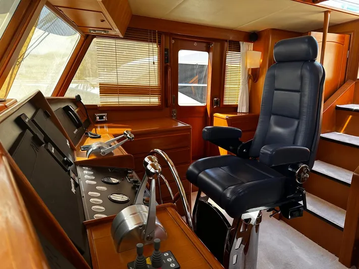 Smaragd Yacht Photos Pics Luxurious helm of a 2003 Fleming 55 yacht with leather captain's chair and control panel.