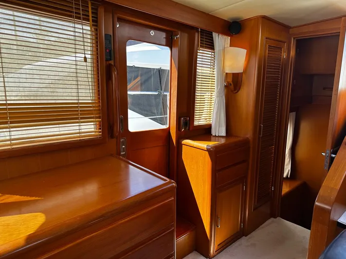 Smaragd Yacht Photos Pics Interior of 2003 Fleming 55 yacht with wooden cabinetry and natural light.