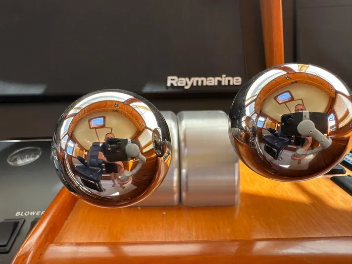 Smaragd Yacht Photos Pics Close-up of a 2003 Fleming 55 yacht's polished throttle controls with Raymarine equipment.