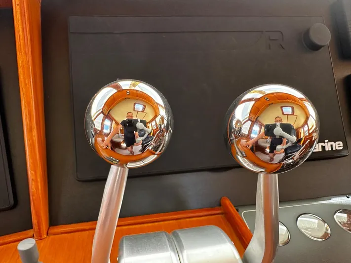 Smaragd Yacht Photos Pics Close-up of chrome throttle levers on a 2003 Fleming 55 yacht.