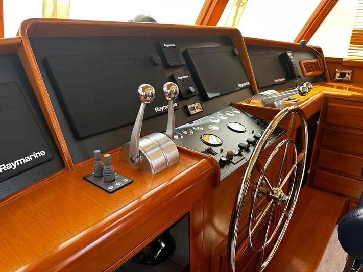 Smaragd Yacht Photos Pics Helm of 2003 Fleming 55 yacht with Raymarine navigation equipment and polished wooden finish.
