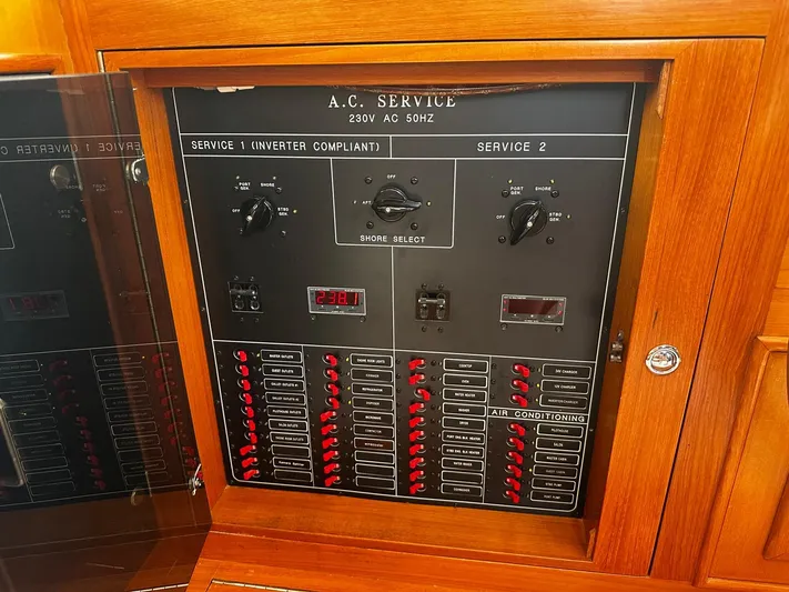 Smaragd Yacht Photos Pics Electrical panel on a 2003 Fleming 55 yacht, featuring AC service controls and switches.