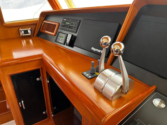 Smaragd Yacht Photos Pics Control panel of a 2003 Fleming 55 yacht with wooden finish and Raymarine equipment.
