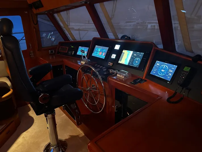 Smaragd Yacht Photos Pics Pilothouse of 2003 Fleming 55 yacht with navigation screens and steering wheel.