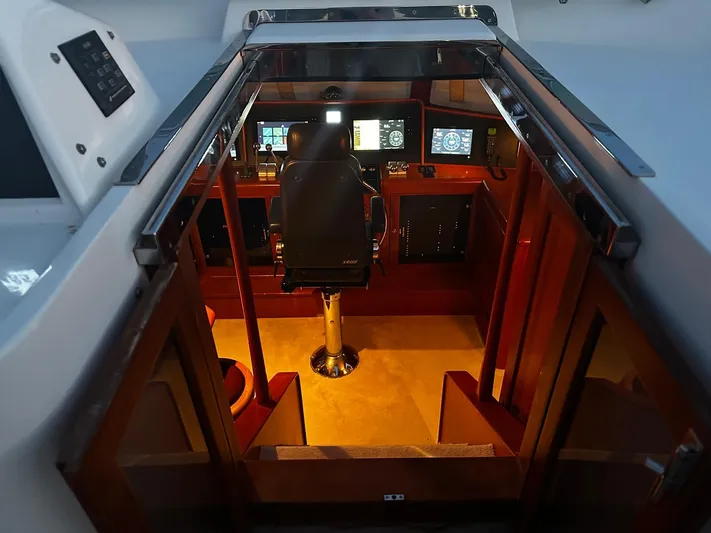 Smaragd Yacht Photos Pics Interior helm of 2003 Fleming 55 yacht with navigation equipment and captain's chair.