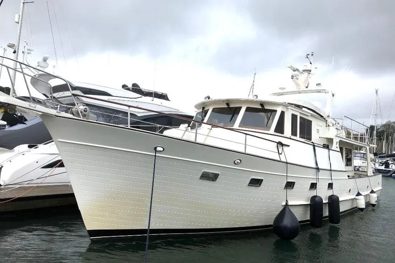 Smaragd Yacht Photos Pics 2003 Fleming 55 yacht docked in marina, overcast sky, side view.