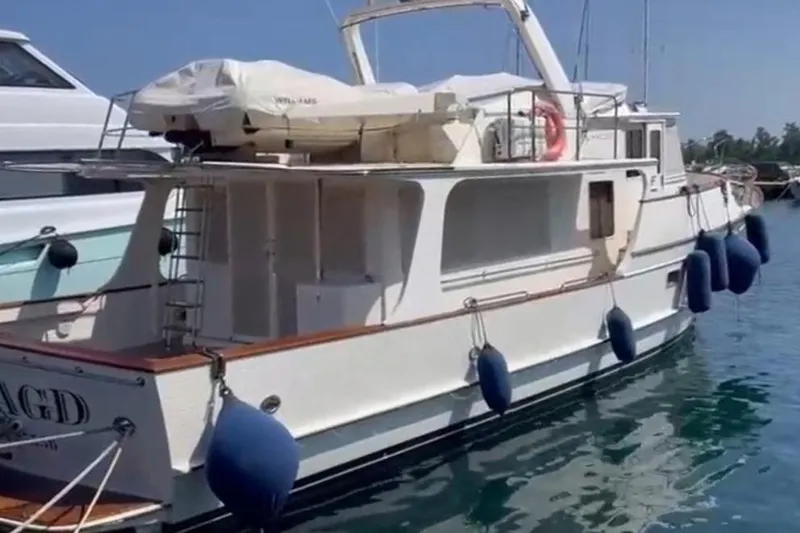 Smaragd Yacht Photos Pics 2003 Fleming 55 yacht docked, featuring white exterior and blue fenders.