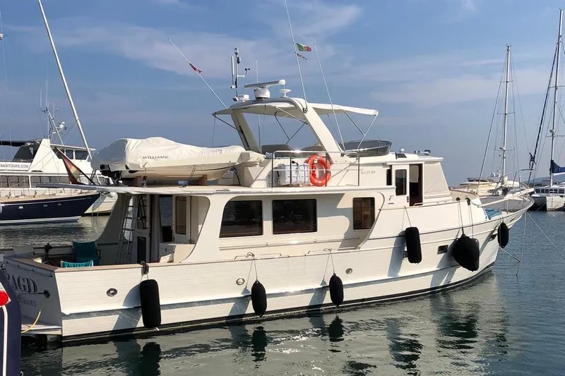 Smaragd Yacht Photos Pics 2003 Fleming 55 yacht docked in a marina, featuring classic design and modern amenities.