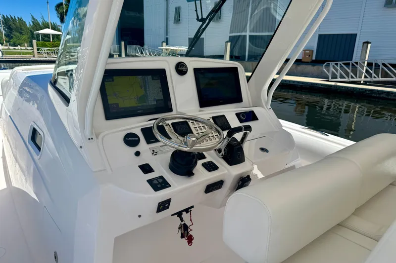  Yacht Photos Pics 2019 Intrepid 407 Panacea boat cockpit with modern navigation controls and steering wheel.