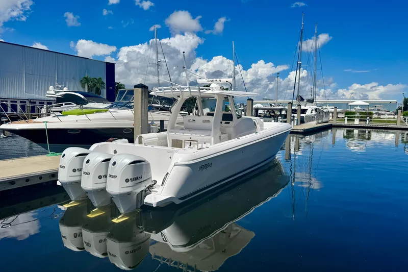  Yacht Photos Pics 2019 Intrepid 407 Panacea boat docked with triple Yamaha engines, under a clear blue sky.