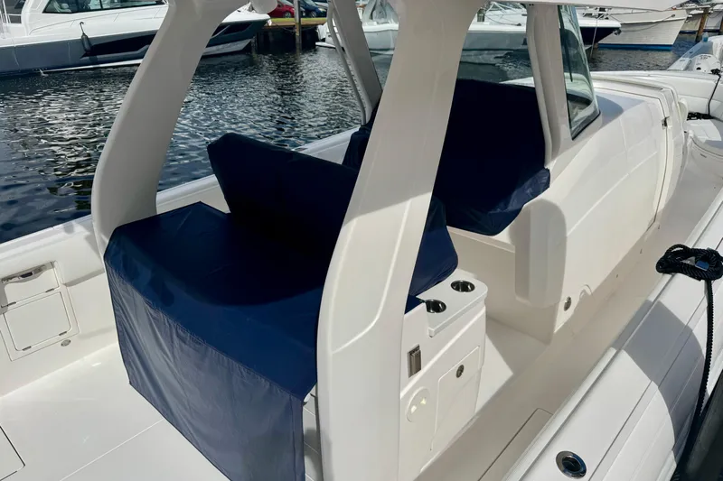  Yacht Photos Pics 2019 Intrepid 407 Panacea boat interior with blue seating, docked at marina.