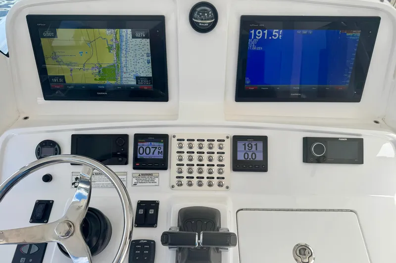  Yacht Photos Pics 2019 Intrepid 407 Panacea helm with navigation screens and controls.