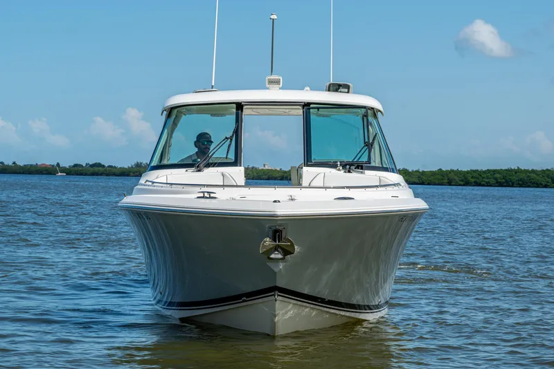  Yacht Photos Pics 2021 Pursuit DC 326 Dual Console boat on calm water, clear sky background.