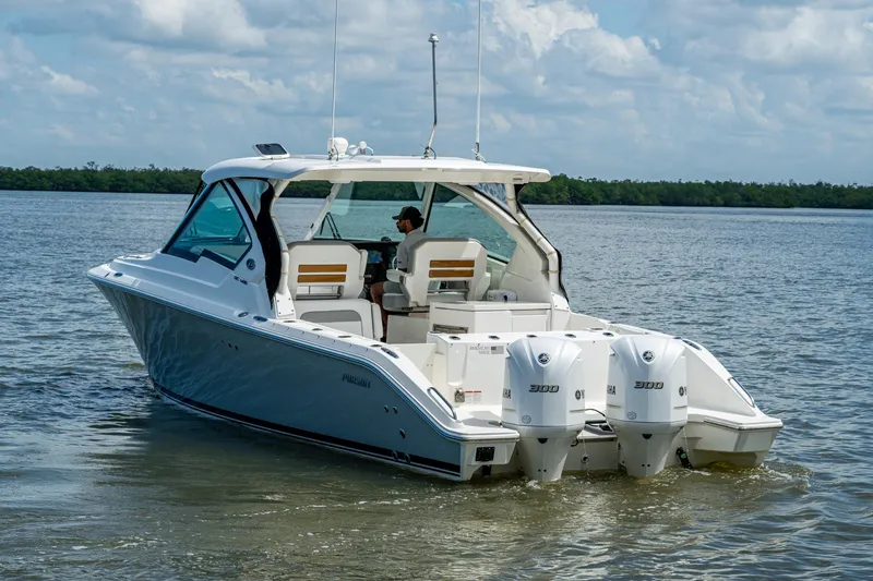  Yacht Photos Pics 2021 Pursuit DC 326 Dual Console boat cruising on calm waters.