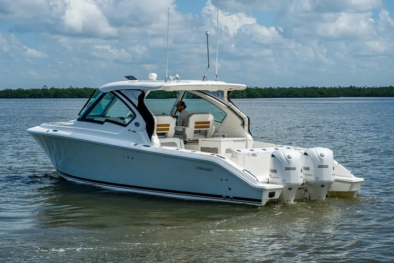  Yacht Photos Pics 2021 Pursuit DC 326 Dual Console boat on calm water, featuring twin Yamaha engines.