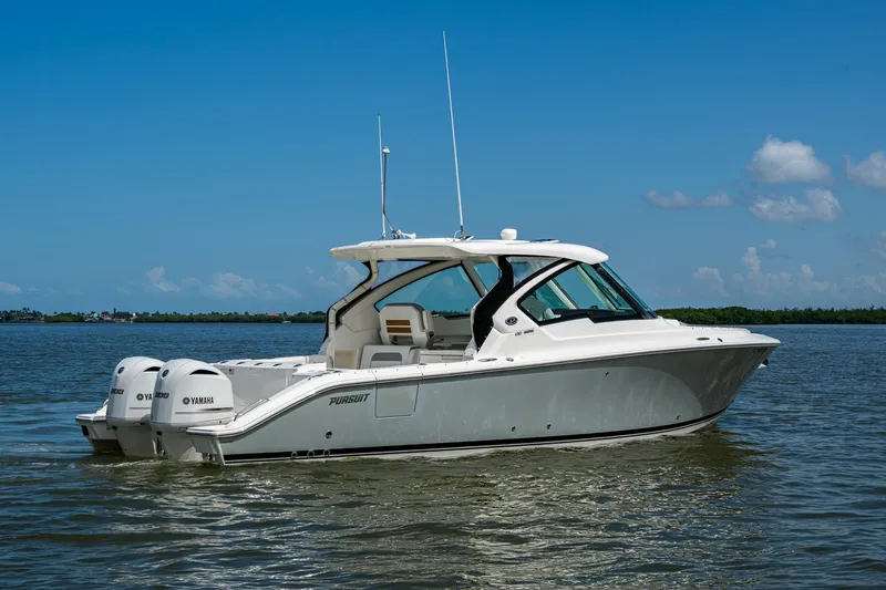  Yacht Photos Pics 2021 Pursuit DC 326 Dual Console boat on calm water under clear blue sky.
