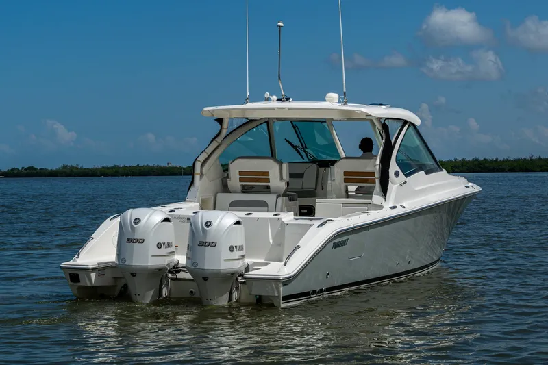  Yacht Photos Pics 2021 Pursuit DC 326 Dual Console boat on calm water, featuring twin Yamaha engines.