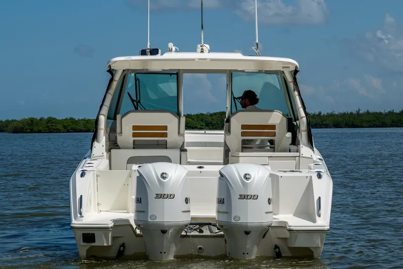  Yacht Photos Pics 2021 Pursuit DC 326 Dual Console boat with twin Yamaha 300 engines on water.