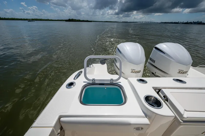 Yacht Photos Pics 2021 Pursuit DC 326 Dual Console boat with Yamaha engines on a calm waterway.