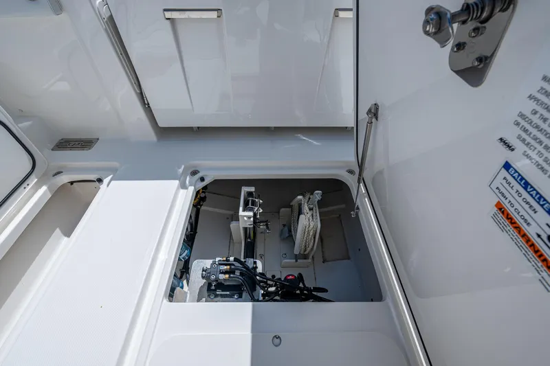  Yacht Photos Pics 2021 Pursuit DC 326 Dual Console storage compartment with ropes and equipment.