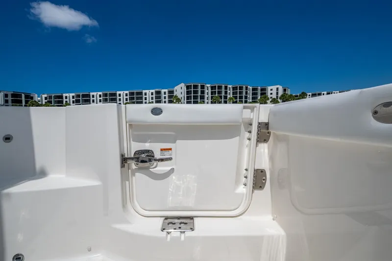  Yacht Photos Pics 2021 Pursuit DC 326 Dual Console boat with open transom door, modern buildings in background.