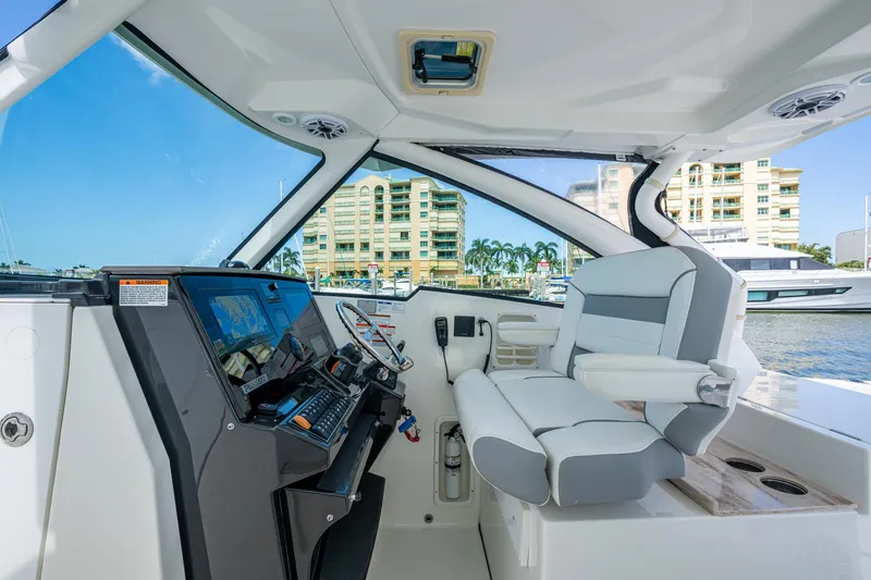  Yacht Photos Pics 2021 Pursuit DC 326 Dual Console boat interior with modern helm and comfortable seating.