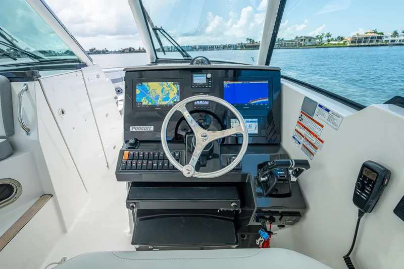  Yacht Photos Pics 2021 Pursuit DC 326 Dual Console boat helm with navigation screens and controls.