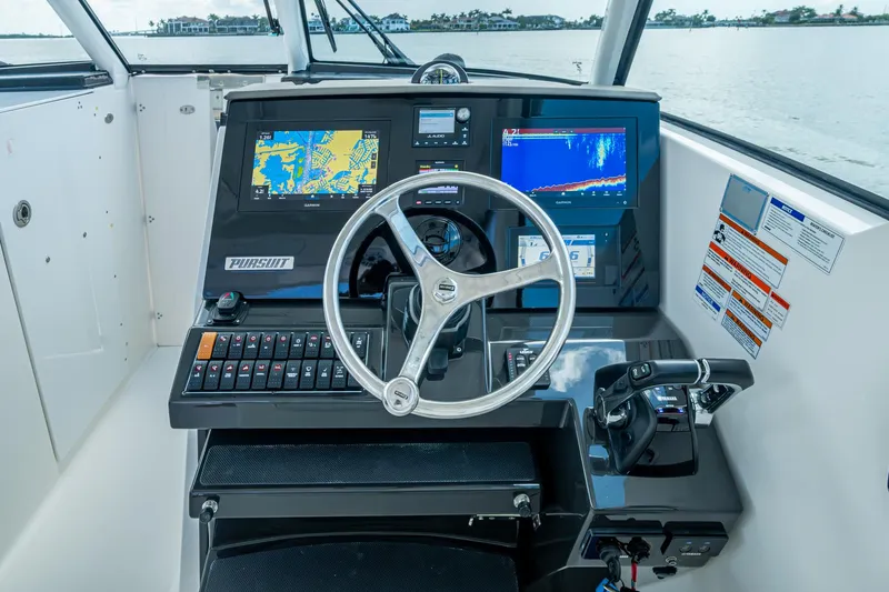  Yacht Photos Pics Helm of 2021 Pursuit DC 326 Dual Console with navigation screens and controls.