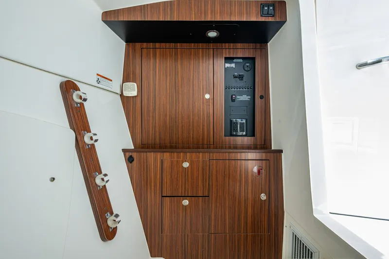  Yacht Photos Pics 2021 Pursuit DC 326 Dual Console interior with wood paneling and control panel.